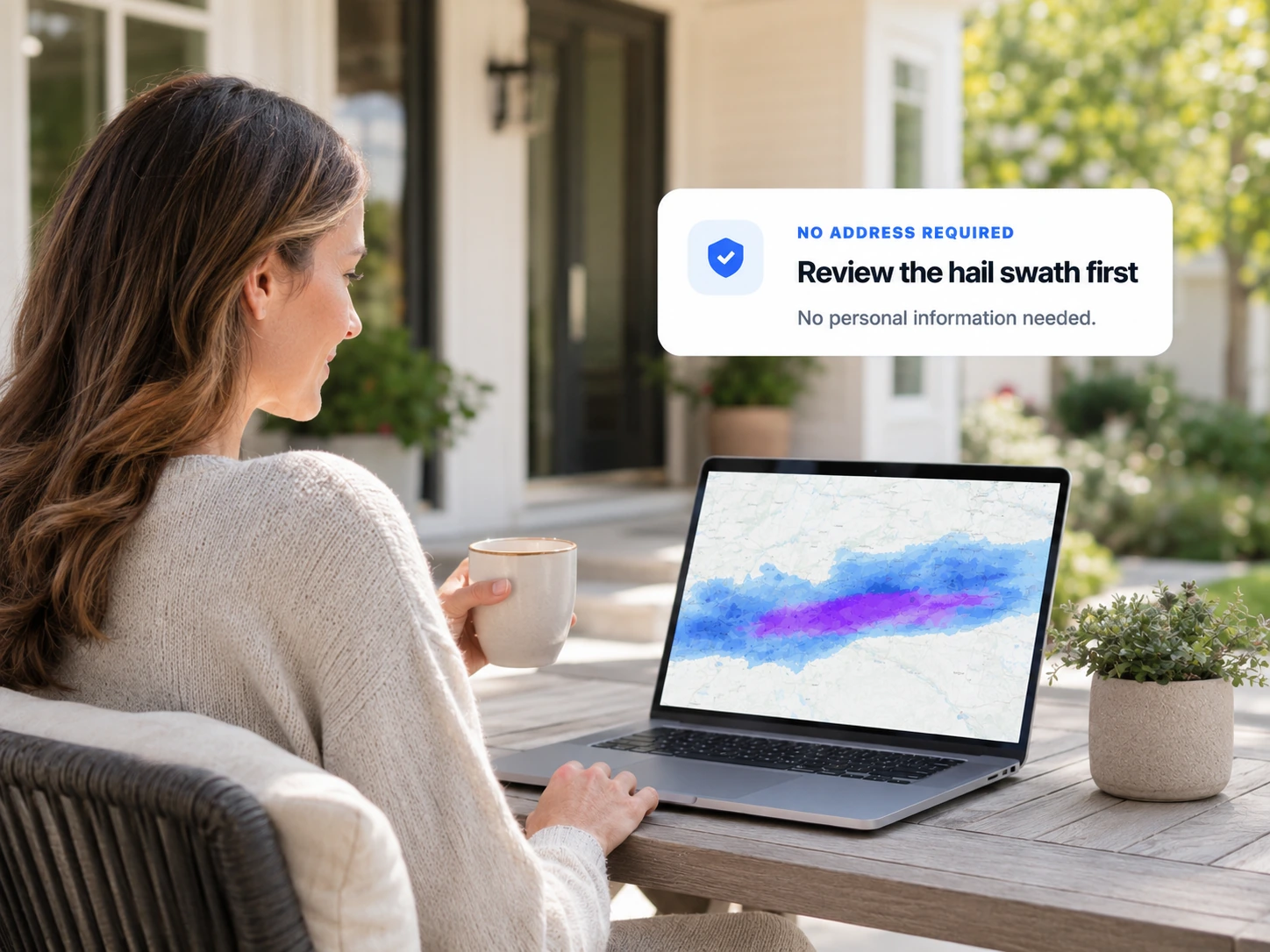 Homeowner reviewing a hail swath map on a laptop